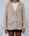 Cable knit cardigan. Double breasted. Collar neckline. Front button down closure. Front pockets. Unlined. oat cardigan sweater. fall sweater. fall outfit