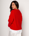 Medium weight knit sweater. Crewneck. Long sleeves. Thin ribbed trim detail at collar, sleeve cuffs, and hemline. Unlined. Pullover style. red pullover sweater. valentines day outfit