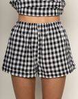 TOP:
Gingham printed flowy tank top
Ruched side ties
Back button closure
Unlined
Length: 21"
Cotton
BOTTOM:
Gingham printed shorts
Elastic waistband
Unlined
Length: 11.5"
Cotton
black and white gingham printed short set
summer set