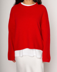 Medium weight knit sweater. Crewneck. Long sleeves. Thin ribbed trim detail at collar, sleeve cuffs, and hemline. Unlined. Pullover style. red pullover sweater. valentines day outfit