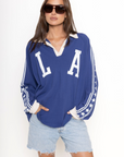 Raglan Rugby Long Sleeve
Featuring a shoutout to Los Angeles across the chest
Star detailed sleeves
Oversized fit
Collar and placket
Blue LA long sleeve top
Dodgers top