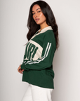Graphic printed knit top. Collar neckline. Long sleeves. Unlined. green graphic long sleeve tee. bonjour tee