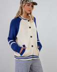 Colorblocked crochet knit cardigan. Crewneck. Long sleeves. Front button down closures. Front pockets. Unlined. ivory and blue sweater cardigan. fall top. fall sweater. oversized sweater