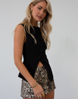 Woven sleeveless top. Asymmetric front button down closures. Back slit. Fully lined. black vest top. going out top. fall outfit. fall top
