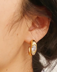 Gold earring with a clear gemstone worn by a person
18K Gold Non-Tarnish CZ Classic C Hoop Earring
18K Gold Plating
Stainless Steel
Cubic Zirconia (CZ)
Measurement (L x W inch): 0.8 x 0.7
Lead-free
Nickel-safe
Hypoallergenic
Water Resistant