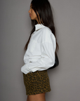 Animal printed denim skirt. Button and zipper fly. Five pocket construction. Frayed hem. Unlined. leopard mini skirt. going out mini skirt.
