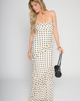 Polka dot printed maxi dress
Tube top
Ruffle on bust trim
Asymmetric ruffle detail on bottom half
Back cut out
Inner rubber grip lining
Side zipper closure
Lined
cream and black polka dot dress
bridal maxi dress