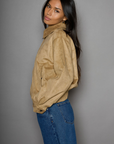 Vegan suede bomber jacket. Collar neckline. Front zipper closure. Elastic hems. Front pockets with snap button closures. Fully lined. tan suede bomber