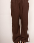 brown Linen track pants
Contrast stripe at side seam
Elastic waistband
Adjustable inner waistband tie
Unlined