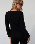 black Woven blazer style top. Long sleeves with faux button closures. Square neckline. Front button down closure. Faux front pockets. Fully lined. black fall top. work top