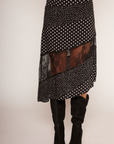 Polka dot asymmetrical skirt
Asymmetrical hem
Lace panel
Side zipper closure
Unlined
black and white polka dot asymmetrical midi skit with a lace panel
