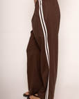 brown Linen track pants
Contrast stripe at side seam
Elastic waistband
Adjustable inner waistband tie
Unlined