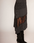 Polka dot asymmetrical skirt
Asymmetrical hem
Lace panel
Side zipper closure
Unlined
black and white polka dot asymmetrical midi skit with a lace panel
