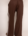 brown Linen track pants
Contrast stripe at side seam
Elastic waistband
Adjustable inner waistband tie
Unlined
