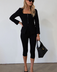 black Woven blazer style top. Long sleeves with faux button closures. Square neckline. Front button down closure. Faux front pockets. Fully lined. black fall top. work top