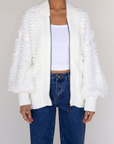 white Fringe crochet knit sweater
Front zipper closure
Long sleeves
Side pockets
Banded hems
Unlined