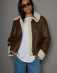 brown Faux leather jacket. Faux Sherpa trim and lining. Front zipper closure. Side pockets. winter jacket. winter coat. fall jacket. fall coat.