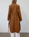 brown Vegan wool trench coat. Collar neckline. Long sleeves. Tie waist. Side pockets. Unlined. tan trench coat. fall outfit. fall jacket