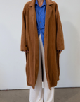 brown Vegan wool trench coat. Collar neckline. Long sleeves. Tie waist. Side pockets. Unlined. tan trench coat. fall outfit. fall jacket