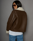 brown Faux leather jacket. Faux Sherpa trim and lining. Front zipper closure. Side pockets. winter jacket. winter coat. fall jacket. fall coat.