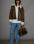 brown Faux leather jacket. Faux Sherpa trim and lining. Front zipper closure. Side pockets. winter jacket. winter coat. fall jacket. fall coat.