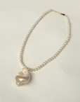 Freshwater pearls with pearlized shell charm necklace
Length: 15" chain with 1" extender
Size and shape of pearl may vary