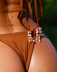 brown Triangle bikini top
Knot detail
A rich, toasted bronze hue
Adjustable neck and back tie
Beading detail on back string
