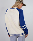 Colorblocked crochet knit cardigan. Crewneck. Long sleeves. Front button down closures. Front pockets. Unlined. ivory and blue sweater cardigan. fall top. fall sweater. oversized sweater