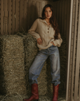 Fuzzy mixed knit crochet sweater. Collar neckline. Front button closures. Long sleeves. Banded hems. Unlined. tan sweater. knit sweater. quarter button up sweater