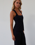 Plaid woven sleeveless top. Front button down closure. Faux front pockets. Adjustable back tie closure. Fully lined. navy blue blouse. work outfit. business casual outfit.