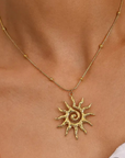 Gold necklace with a sun-shaped pendant
18K Gold Non-Tarnish Boho Sun Necklace
18K Gold Plated
Stainless Steel
Pendant Size: 1.5" / Chain Length: 15.57" / Extension Length: 2"
Lead-free
Nickel-safe
Hypoallergenic
Water Resistant