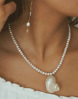 Freshwater pearls with pearlized shell charm necklace
Length: 15" chain with 1" extender
Size and shape of pearl may vary