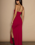 Knit maxi dress. Strapless neckline. Ruched front. Side slit. Partially lined. red strapless maxi dress. holiday maxi dress. holiday look.