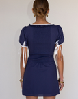 blue Short sleeve mini dress
Front and sleeve tie
Hook eye front closure
Contrast trim stitching
Back smocking
Side zipper
Lined
summer mini dress
spring mini dress