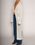 white Thin knit longline cardigan
Long sleeves
Front button down closure
Front pockets
Side slits
Unlined
pool cover up
beach cover up