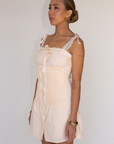 tan Woven coquette mini dress
Front bow detail
Front button closure
Adjustable lace and ribbon shoulder straps
Pintuck details on bodice
Smocked backing
Lined
summer mini dress
spring mini dress