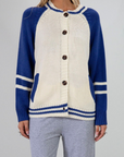 Colorblocked crochet knit cardigan. Crewneck. Long sleeves. Front button down closures. Front pockets. Unlined. ivory and blue sweater cardigan. fall top. fall sweater. oversized sweater