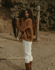 Tan brown faux suede jacket. Front zipper closure. Front and side pockets. Long sleeves with button closures. Fully lined. suede bomber jacket