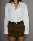 Animal printed denim skirt. Button and zipper fly. Five pocket construction. Frayed hem. Unlined. leopard mini skirt. going out mini skirt.