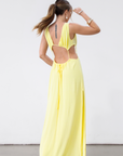 Crinkle woven sleeveless maxi dress. Waist cut outs. Side slits. Back tie closure. Back drawstring waist closure. Partially lined. vacation dress. beach dress. yellow maxi dress.