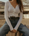Ribbed knit top. Long sleeves. With elastic sleeve openings. Front button down closures. Unlined. Crochet lace trim. White long sleeve