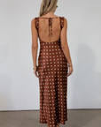brown and white Polka dot printed satin maxi dress. Fixed straps. Lace trimmed neckline. Front drawstring closure. Side hook and eye and zipper closures. Back tie closure. Elastic back. Fully lined. fall dress. fall wedding guest dress. fall outfit