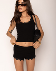 Low-rise waist soft jersey fabric micro short
Tonal daisy appliqué along the hemline
Elastic waistband
Unlined
black mini shorts with daisies hemline