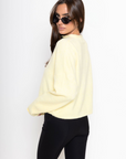 Fuzzy knit cardigan
Crewneck
Front button down closures
Long sleeves
Unlined
yellow cardigan