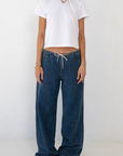 blue Wide leg denim pant
Hidden waistband with adjustable drawstring
5 pocket construction
Button closure
Unlined
Cotton/Polyester