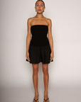 Strapless dress. Knit bodice. Woven skirt. Elastic neckline. Inner rubber grip lining. Side hook and eye and zipper closures. Unlined. Black mini dress. fall dress. holiday dress. friendsgiving dress. thanksgiving dress. summer dress. little black dress