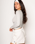 Ribbed knit top. Long sleeves. With elastic sleeve openings. Front button down closures. Unlined. Crochet lace trim. grey long sleeve