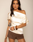Satin asymmetrical off the shoulder top
Shoulder button closure
Front drape detail
Relaxed fit
Can be worn multiple ways
Side zipper closure
ivory satin short sleeve top