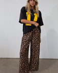 Animal printed woven pants. Elastic waistband with drawstring closure. Unlined.