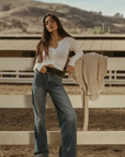 Ribbed knit top. Long sleeves. With elastic sleeve openings. Front button down closures. Unlined. Crochet lace trim. White long sleeve